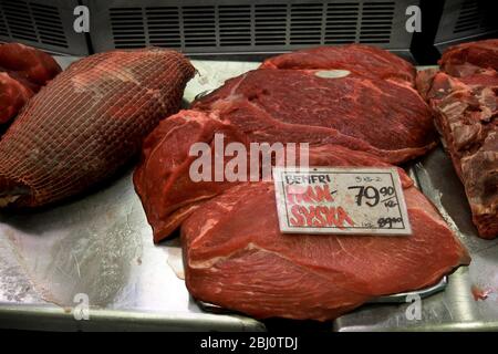 Whole rump steak for sale on counter of butcher in covered market in Gothenburg, Sweden - Stock Photo