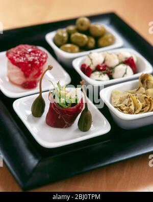 Tray of tapas dishes as executive desk lunch - Stock Photo