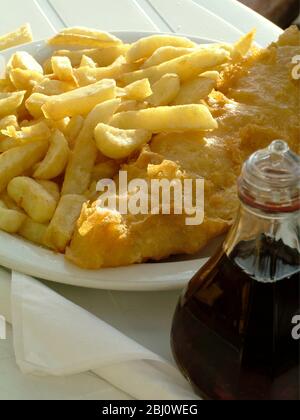 Traditional fish and chips at outdoor cafe on the seafront at Hastings - Stock Photo