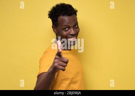 Cheerful attractive african man pointing on you making a choice. Stock Photo
