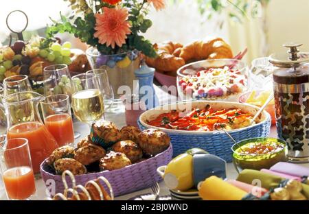 Food laid out on table for brunch party - Stock Photo
