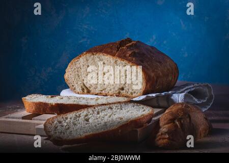 Homemade bread laid on a rustic table in a vintage setting Stock Photo