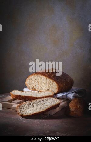 Homemade bread laid on a rustic table in a vintage setting Stock Photo