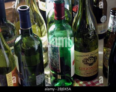 Empty wine bottles gathered up after a party. - Stock Photo