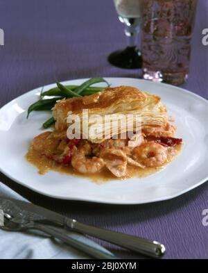 Festive dish of mixed seafood in wine infused sauce topped with puff pastry - Stock Photo