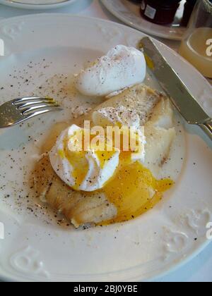 Two poached eggs on smoked haddock at breakfast in Scottish hotel - Stock Photo