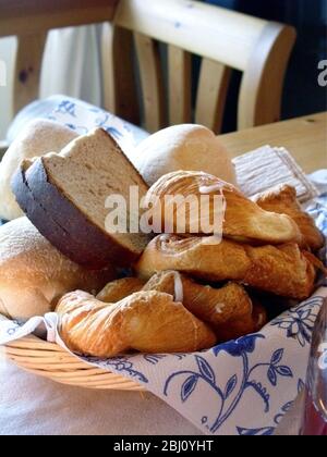 A collection of various breads and pastries in basket on table. Sweden - Stock Photo