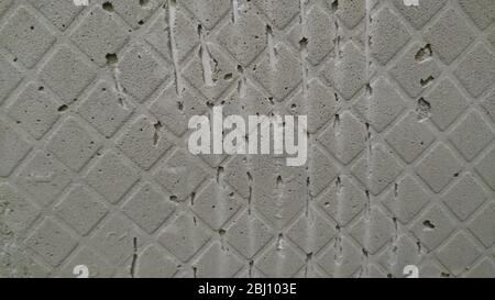 Grooves from the spatula on the wall after removing the tile Stock Photo