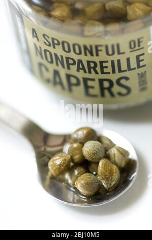 A spoonful of Nonpareille capers - Stock Photo