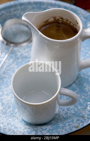 Real coffee made simply in jug with tea strainer - Stock Photo