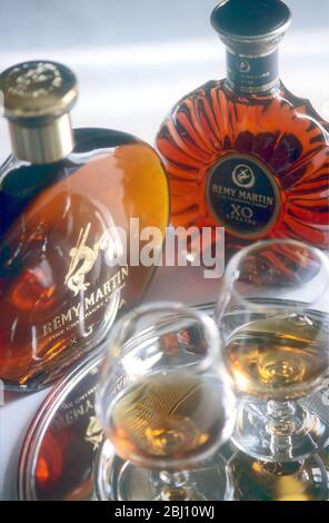 Two bottles of good brandy with classic balloon glasses - - Stock Photo