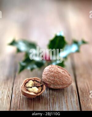 Walnuts and holly leaves - Stock Photo