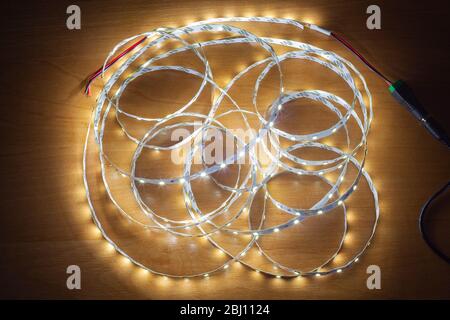 LED strip on a wooden table, close-up Stock Photo