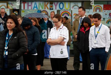 Derby, Derbyshire, UK. 28th April 2020. Royal Derby Hospital Staff and members of the public pause for a minuteÕs silence to remember key workers who have died because of Covid-19 during the coronavirus pandemic lockdown. Credit Darren Staples/Alamy Live News. Stock Photo