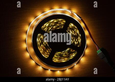 LED strip on a wooden table, close-up Stock Photo