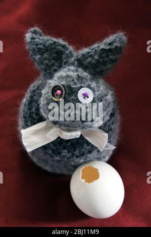wool bunny with pierced egg Stock Photo