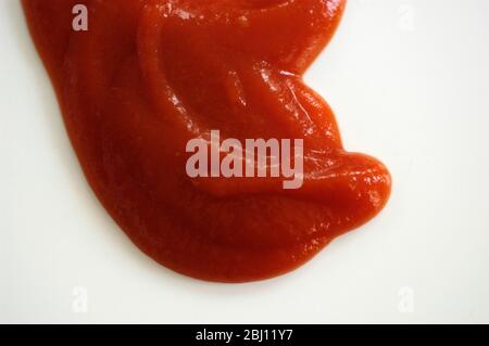 Dollop of tomato ketchup on white background - Stock Photo