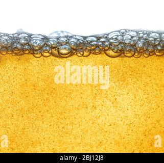 Yellow liquid with beer foam, or industrial oil from oil. Human fat obesity. Close-up. Stock Photo