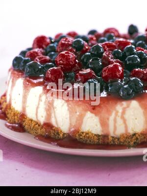 Cheesecake with topping of raspberries and blueberries - Stock Photo