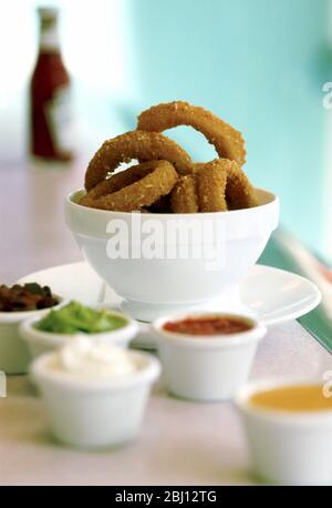 Onion rings and dips - Stock Photo