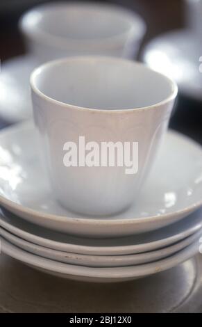 White cups and saucers - Stock Photo