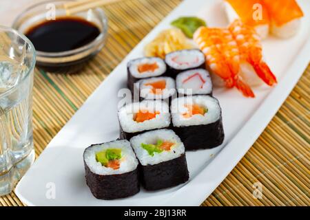 Traditional Japanese sushi platter. Hosomaki and makizushi with various fillings, nigiri with salmon and shrimp Stock Photo