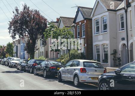 London/UK-1/08/18: pastel-colored terraced houses on White Hart Lane in Barnes. Terrace house is a form of medium-density housing, whereby a row of at Stock Photo