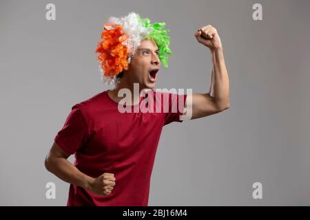 young man wearing tricolour wig and cheering, independence day Stock Photo