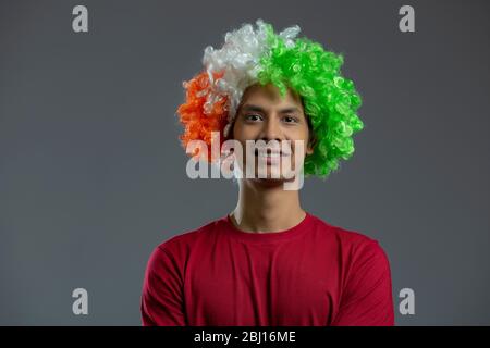young man wearing tricolour wig and smiling , independence day Stock Photo