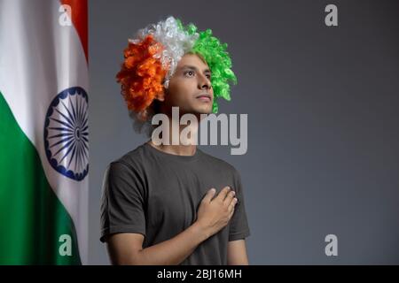 young man wearing a tricolour wig feeling patriotic, independence day Stock Photo