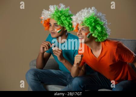 young boys wearing tricolour wig and cheering, independence day Stock Photo
