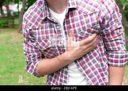 Man having chest pain - heart attack, outdoors Stock Photo