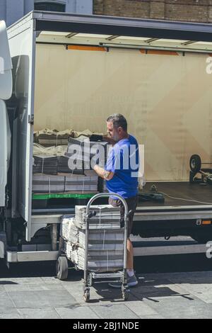 London/UK-1/08/18: man unloading the London Evening Standard at The Quadrant in Richmond. The Evening Standard is a local, free daily newspaper, publi Stock Photo