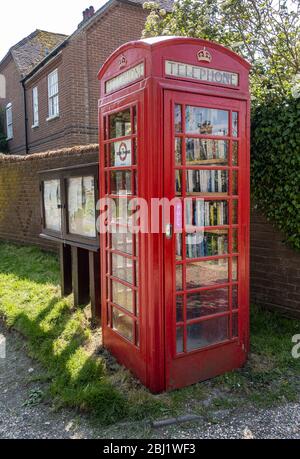 Up Somborne local book exchange in red telephone box in Hampshire, England, UK Stock Photo