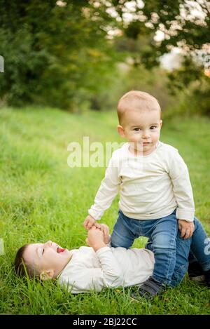 Portrait of two young boys playing in a meadow. Stock Photo