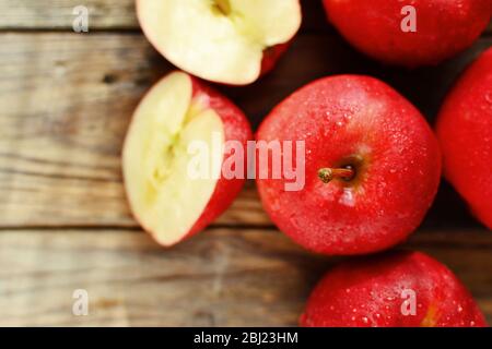 Red apples on a wooden background. Healthy ripe fruits, raw food diet, vegetarian. Dabinett Apple. Top view Stock Photo