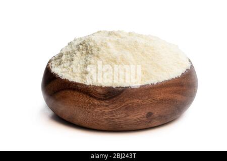 Full  fat powdered milk in wooden bowl isolated on white Stock Photo