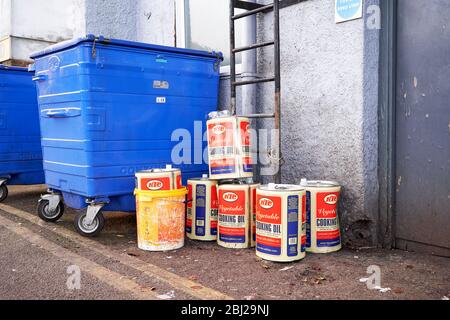 Empty cooking oil drums waiting to be collected for recycling at the rear of a fast food takeaway Stock Photo