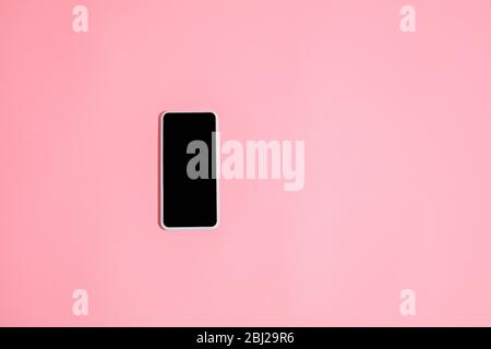 Gadgets, device on top view, blank screen with copyspace, minimalistic style. Technologies, modern, marketing. Negative space for ad. Coral on background. Stylish, trendy. Workplace for productivity. Stock Photo