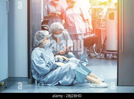 Concept of medecine surgery, Kovid 19. Tired, exhausted doctor after an exhausting shift in the intensive care unit. Pandemic, isolation, epidemic Stock Photo