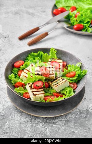 Salad with grilled cheese, tomato and wine sauce Stock Photo