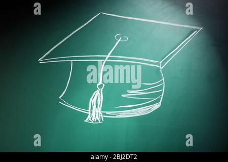 Bachelor hat drawing on blackboard background Stock Photo