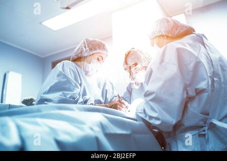 A team of doctors is fighting for the life of the patient. Intensive care unit, fight against viruses and bacretria, Covid 19. Pulmonary pneumonia is Stock Photo