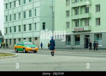 Pyongyang / DPR Korea - November 13, 2015: Female traffic police officer directing traffic in Pyongyang, North Korea Stock Photo