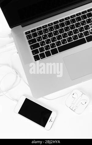 Computer peripherals and laptop accessories on white wooden background ...