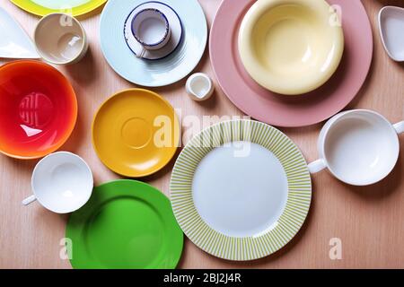 Set of colourful plates on the table Stock Photo