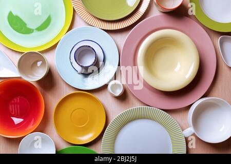 Set of colourful plates on the table Stock Photo