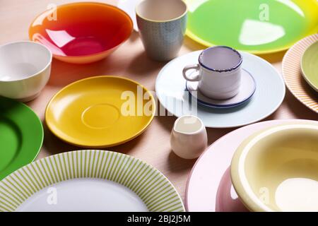 Set of colourful plates on the table Stock Photo