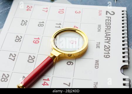 Concept image of business and meetings. Calendar to remind you an important appointment and Magnifying glass Stock Photo