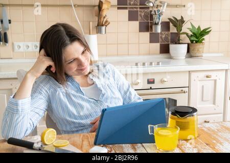 Female enjoys staying at home - watching movie, drinking tea Stock Photo